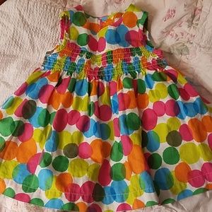 Colorful baby party dress with white cardigan.